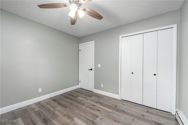 5417 Edgewood Dr, Lorain, OH 44053 - unfurnished bedroom featuring baseboard heating, wood finished floors, a closet, and a ceiling fan