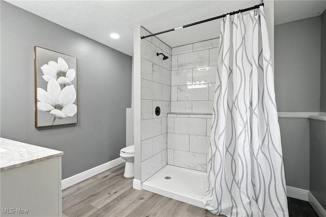 5417 Edgewood Dr, Lorain, OH 44053 - full bathroom featuring wood finished floors, a tile shower, vanity, and recessed lighting