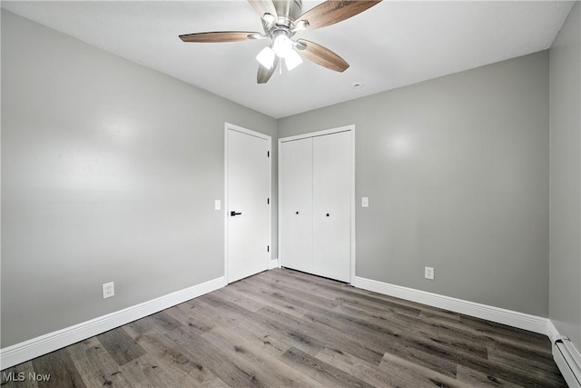 5417 Edgewood Dr, Lorain, OH 44053 - unfurnished bedroom with wood finished floors, a closet, a baseboard heating unit, and a ceiling fan