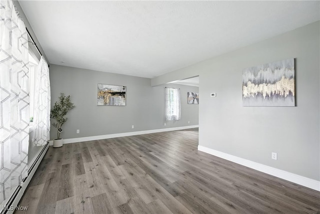 5417 Edgewood Dr, Lorain, OH 44053 - empty room featuring baseboard heating and wood finished floors
