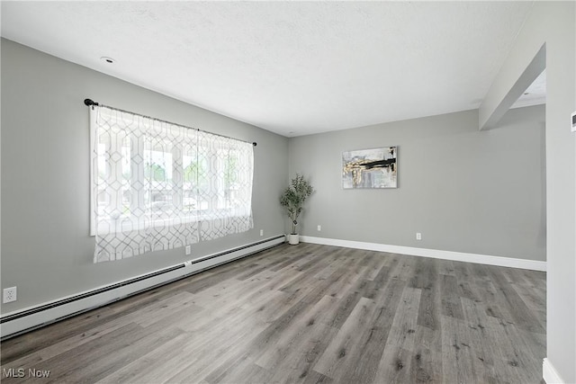 5417 Edgewood Dr, Lorain, OH 44053 - unfurnished room featuring a baseboard radiator and wood finished floors