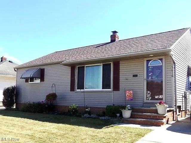 15616 Greendale Rd, Maple Heights, OH 44137 - view of front of home with a front lawn, a chimney, and roof with shingles