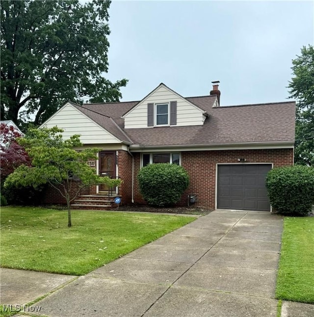 450 E 255th St, Euclid, OH 44132 - view of front facade featuring an attached garage, roof with shingles, a front yard, a chimney, and concrete driveway