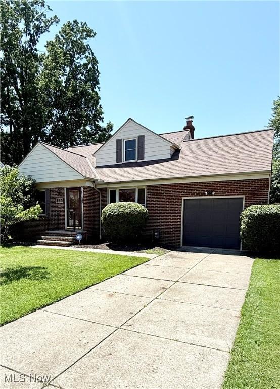 450 E 255th St, Euclid, OH 44132 - traditional-style home with a garage, brick siding, and concrete driveway