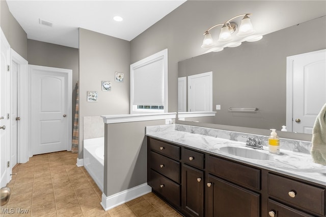 3202 S Lipkey Rd, North Jackson, OH 44451 - full bathroom featuring vanity, a garden tub, and tile patterned floors