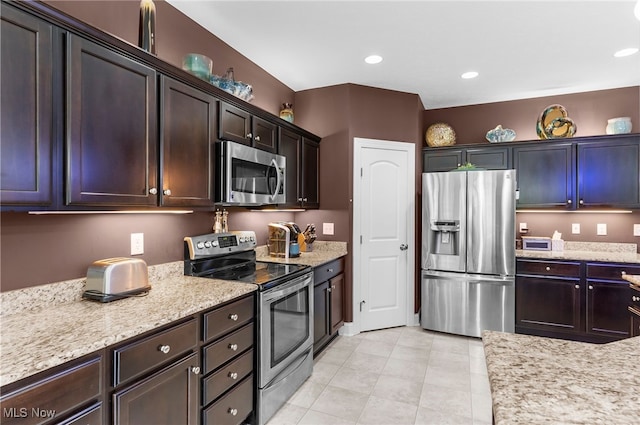 3202 S Lipkey Rd, North Jackson, OH 44451 - kitchen featuring stainless steel appliances, dark brown cabinetry, light tile patterned floors, light stone countertops, and recessed lighting