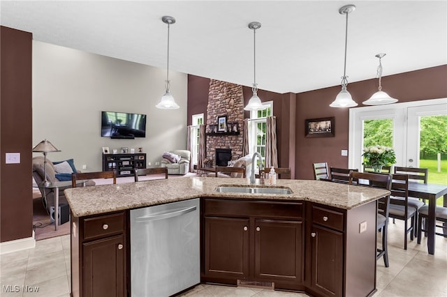 3202 S Lipkey Rd, North Jackson, OH 44451 - kitchen with stainless steel dishwasher, a stone fireplace, dark brown cabinets, pendant lighting, and open floor plan