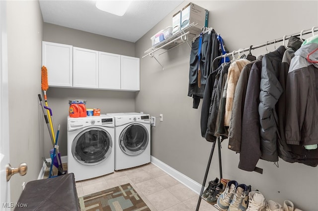 3202 S Lipkey Rd, North Jackson, OH 44451 - laundry area featuring cabinet space, independent washer and dryer, and light tile patterned flooring