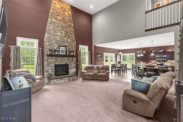 3202 S Lipkey Rd, North Jackson, OH 44451 - living room featuring a towering ceiling, a stone fireplace, and carpet flooring