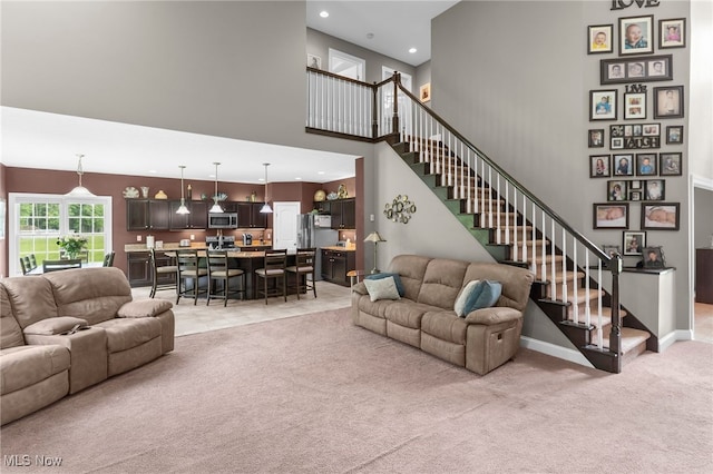 3202 S Lipkey Rd, North Jackson, OH 44451 - living room with light carpet, a high ceiling, stairs, and recessed lighting