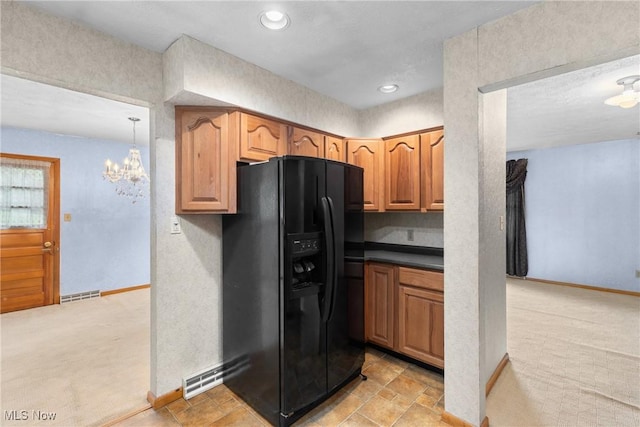 53979 Colerain Pike, Martins Ferry, OH 43935 - kitchen featuring black fridge, a chandelier, dark countertops, light colored carpet, and recessed lighting