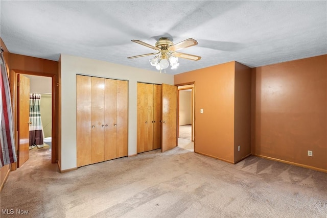 53979 Colerain Pike, Martins Ferry, OH 43935 - unfurnished bedroom featuring two closets, carpet, and ceiling fan