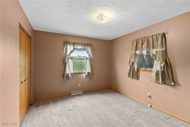 53979 Colerain Pike, Martins Ferry, OH 43935 - empty room featuring carpet and a textured ceiling