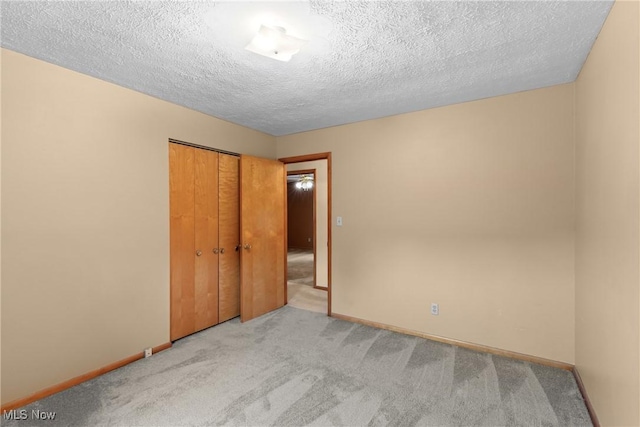 53979 Colerain Pike, Martins Ferry, OH 43935 - unfurnished bedroom featuring carpet, a closet, and a textured ceiling