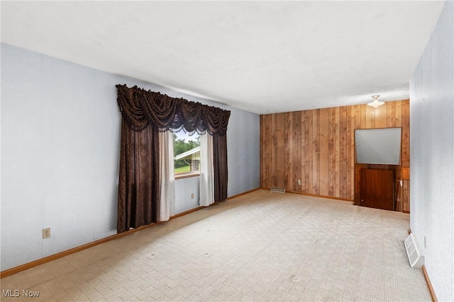 53979 Colerain Pike, Martins Ferry, OH 43935 - empty room with wooden walls and light colored carpet