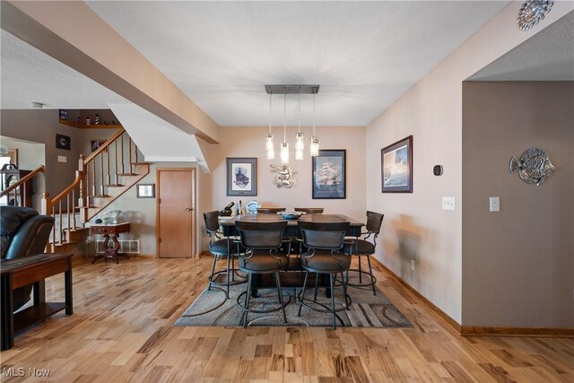 4869 Coleman Dr, Akron, OH 44319 - dining space featuring light wood-style floors and stairs