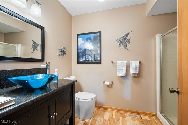 4869 Coleman Dr, Akron, OH 44319 - full bathroom with a stall shower, vanity, and wood finished floors