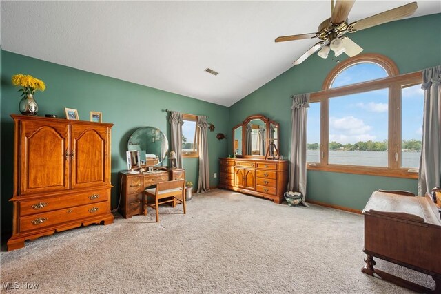 4869 Coleman Dr, Akron, OH 44319 - bedroom with light carpet, multiple windows, vaulted ceiling, a ceiling fan, and a water view
