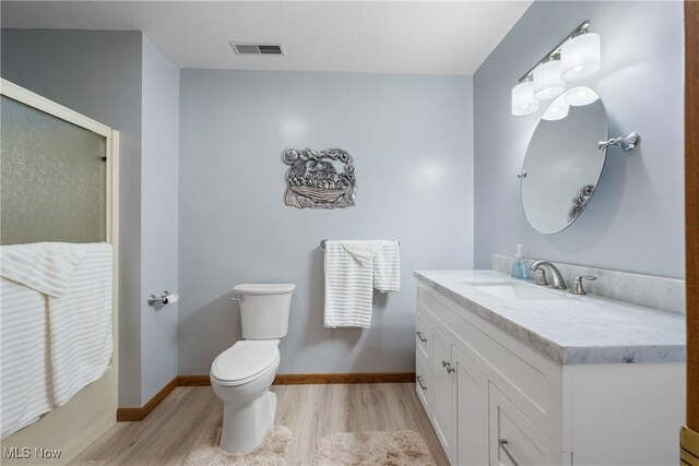 4869 Coleman Dr, Akron, OH 44319 - bathroom with wood finished floors, vanity, and a shower with door