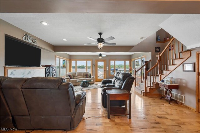 4869 Coleman Dr, Akron, OH 44319 - living area with light wood-style flooring, a textured ceiling, a ceiling fan, stairs, and recessed lighting