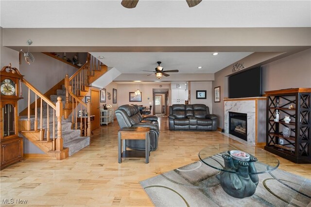 4869 Coleman Dr, Akron, OH 44319 - living room featuring ceiling fan, light wood-style floors, stairs, a premium fireplace, and recessed lighting