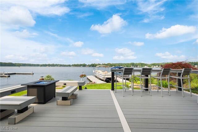 4869 Coleman Dr, Akron, OH 44319 - wooden deck featuring a dock, a water view, and a fire pit