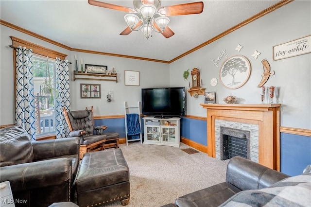820 Walnut St, Caldwell, OH 43724 - carpeted living area with a ceiling fan, a tiled fireplace, and crown molding