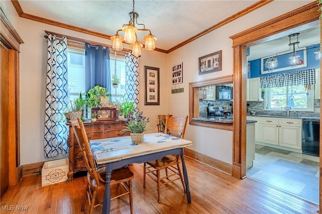 820 Walnut St, Caldwell, OH 43724 - dining space featuring a chandelier, light wood finished floors, ornamental molding, and a textured ceiling