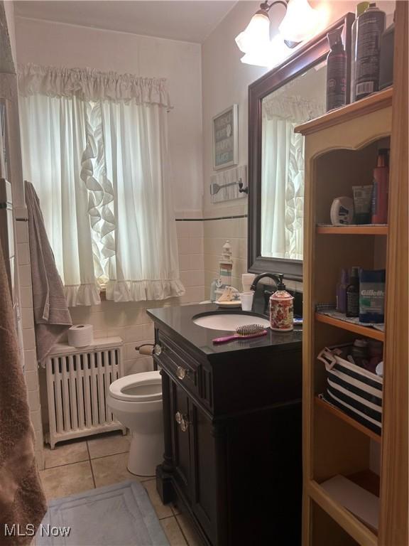 3601 State St, Weirton, WV 26062 - bathroom featuring radiator, tile patterned floors, vanity, and tile walls