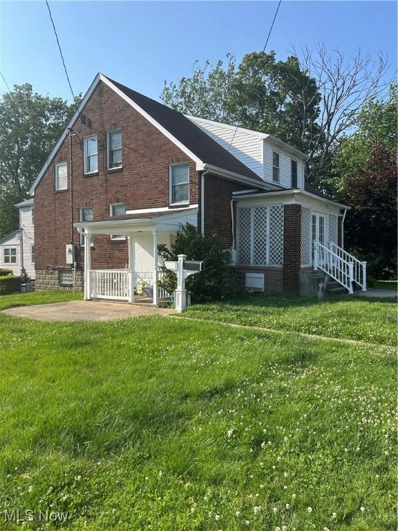 3601 State St, Weirton, WV 26062 - rear view of house featuring brick siding and a lawn