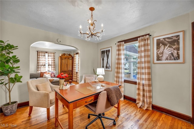 14914 Tudor Ave, Cleveland, OH 44111 - office area featuring arched walkways, light wood finished floors, and a chandelier
