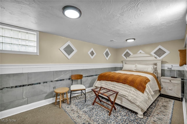 14914 Tudor Ave, Cleveland, OH 44111 - bedroom featuring a wainscoted wall and a textured ceiling