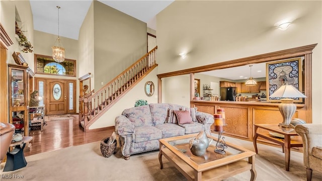 14751 Lancelot Ln E, North Royalton, OH 44133 - living area with a high ceiling, stairway, and light carpet