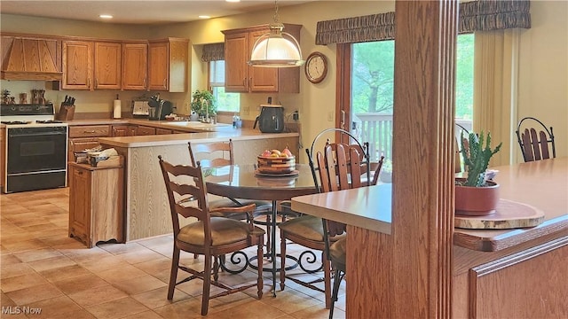 14751 Lancelot Ln E, North Royalton, OH 44133 - kitchen with range, premium range hood, recessed lighting, a peninsula, and light countertops