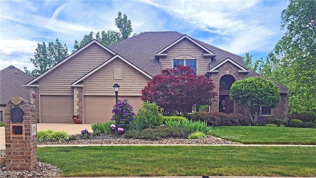 14751 Lancelot Ln E, North Royalton, OH 44133 - view of front of property with brick siding, a front yard, concrete driveway, and roof with shingles