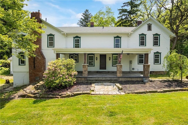 2132 Martin Rd, Mogadore, OH 44260 - view of front facade with a front lawn, a chimney, and covered porch