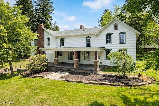 2132 Martin Rd, Mogadore, OH 44260 - view of front of house with a front lawn, a chimney, and a porch