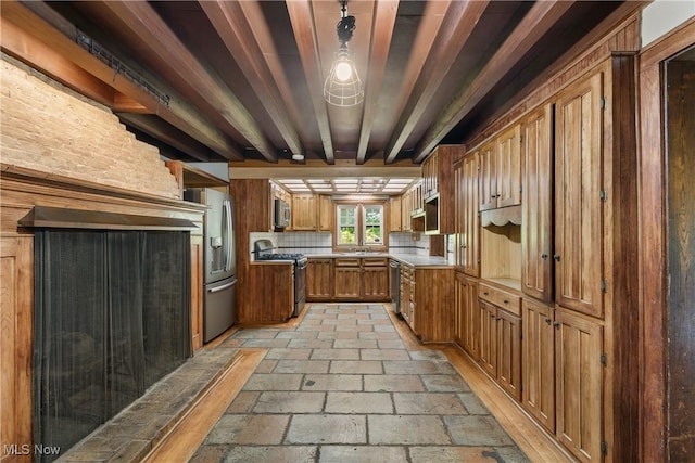 2132 Martin Rd, Mogadore, OH 44260 - kitchen featuring stainless steel appliances, brown cabinets, tasteful backsplash, stone tile flooring, and light countertops