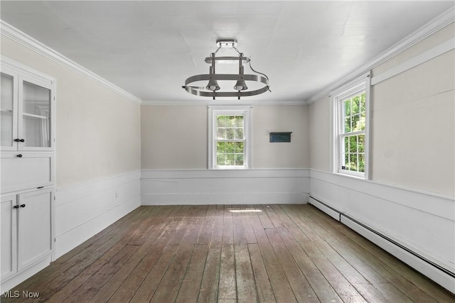2132 Martin Rd, Mogadore, OH 44260 - empty room featuring a baseboard heating unit, dark wood-style floors, healthy amount of natural light, a chandelier, and crown molding