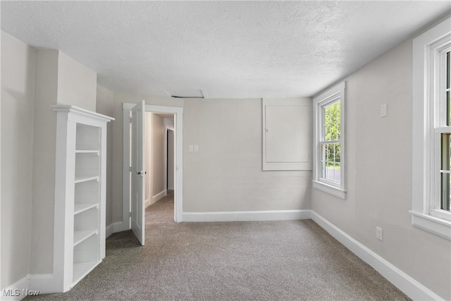 2132 Martin Rd, Mogadore, OH 44260 - unfurnished bedroom featuring a textured ceiling and carpet flooring