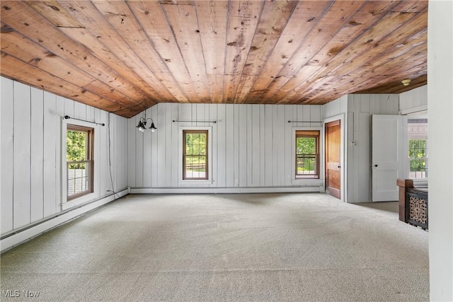 2132 Martin Rd, Mogadore, OH 44260 - empty room featuring wooden ceiling, vaulted ceiling, healthy amount of natural light, carpet, and wooden walls