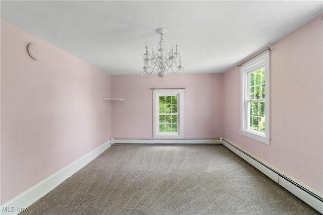 2132 Martin Rd, Mogadore, OH 44260 - carpeted spare room featuring a baseboard heating unit and a chandelier