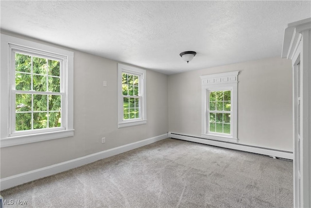 2132 Martin Rd, Mogadore, OH 44260 - empty room featuring a baseboard heating unit, a textured ceiling, and carpet floors