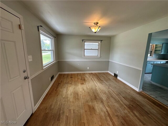 814 Almasy Dr, Campbell, OH 44405 - unfurnished dining area with wood finished floors and baseboards