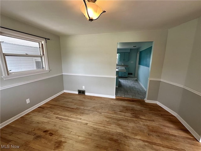 814 Almasy Dr, Campbell, OH 44405 - spare room with wood finished floors and baseboards