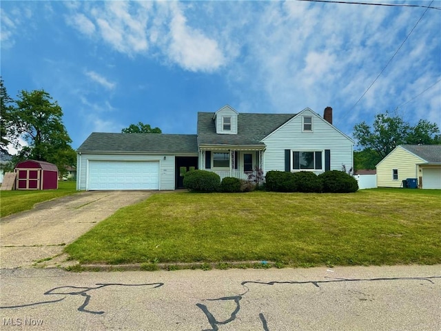 814 Almasy Dr, Campbell, OH 44405 - view of front of house featuring a storage shed, an attached garage, driveway, a chimney, and a front yard