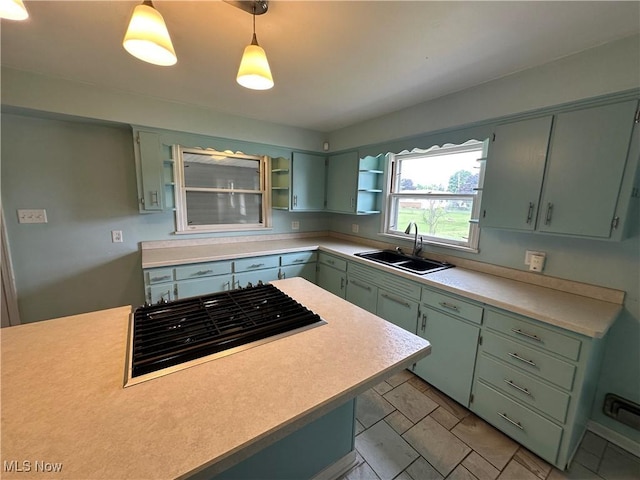 814 Almasy Dr, Campbell, OH 44405 - kitchen with open shelves, light countertops, stovetop, and green cabinetry