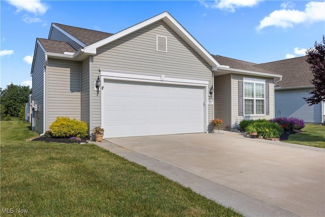 221 Kensington Way, Elyria, OH 44035 - single story home featuring an attached garage, concrete driveway, a front lawn, and a shingled roof