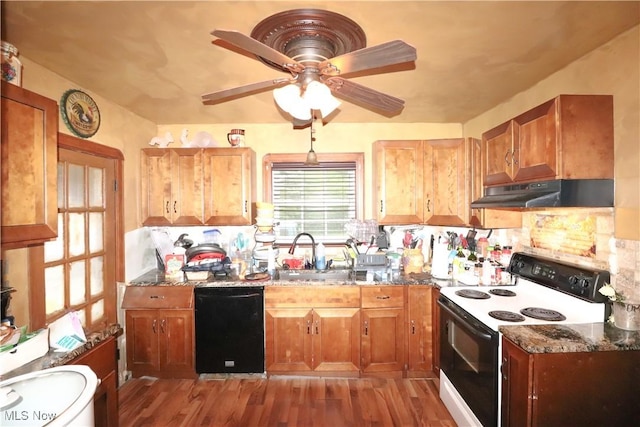 2313 Graustark Path, Wooster, OH 44691 - kitchen with black dishwasher, electric stove, under cabinet range hood, light wood finished floors, and dark stone counters