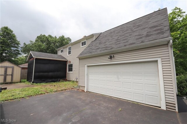 2313 Graustark Path, Wooster, OH 44691 - view of front of property featuring a storage shed, roof with shingles, and asphalt driveway